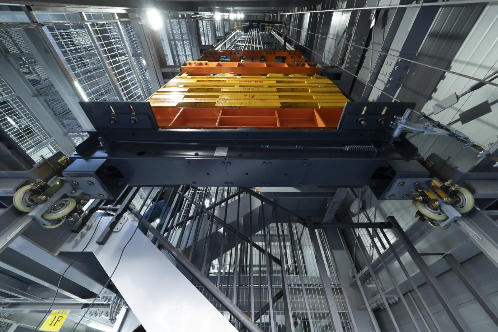 Elevator car seen from below in the hoistway